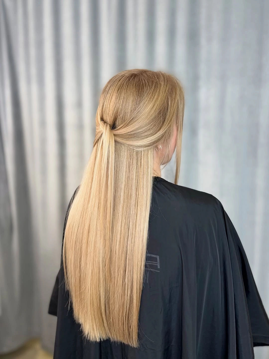 Very long blonde hair with smooth half-up wrapped back section