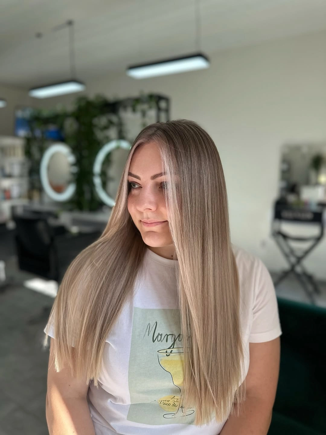 Long light-blonde straight hair with centered part and narrow silhouette