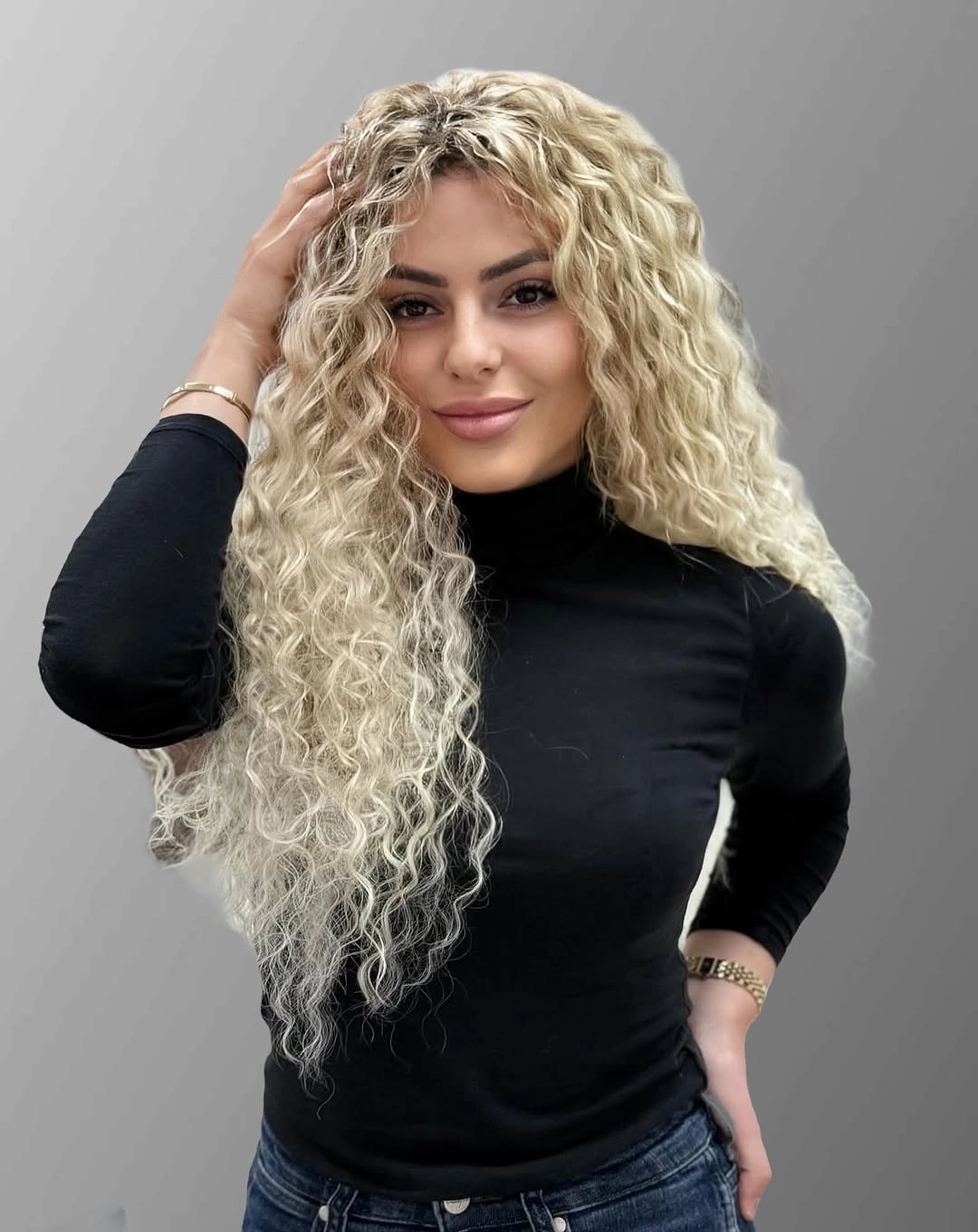 Long pale blonde hair with repeated small curls throughout