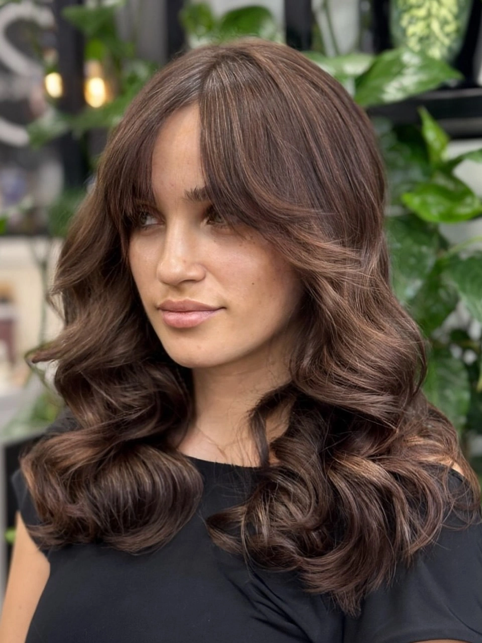 Brunette hair with sweeping front sections and broad curled lengths