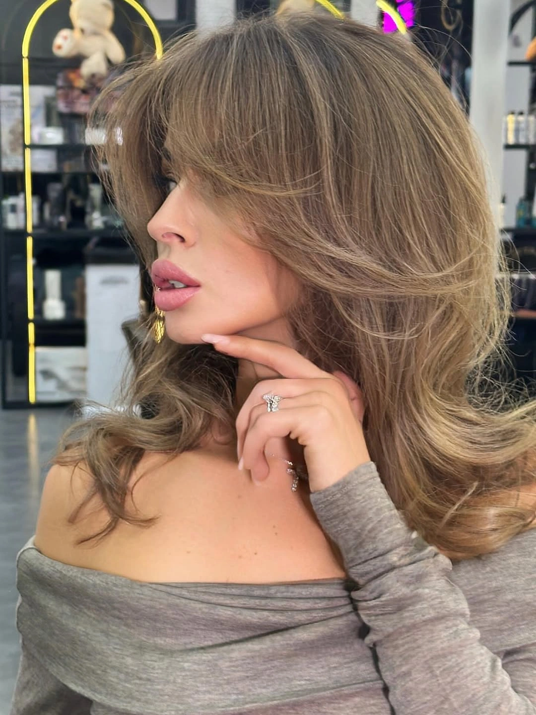Light brown shoulder-length hair with sweeping fringe and flipped ends