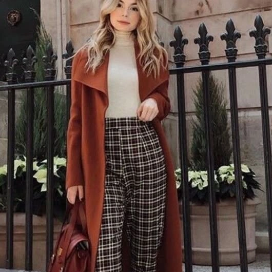 Woman in light blue wide-leg outfit and dark sneakers