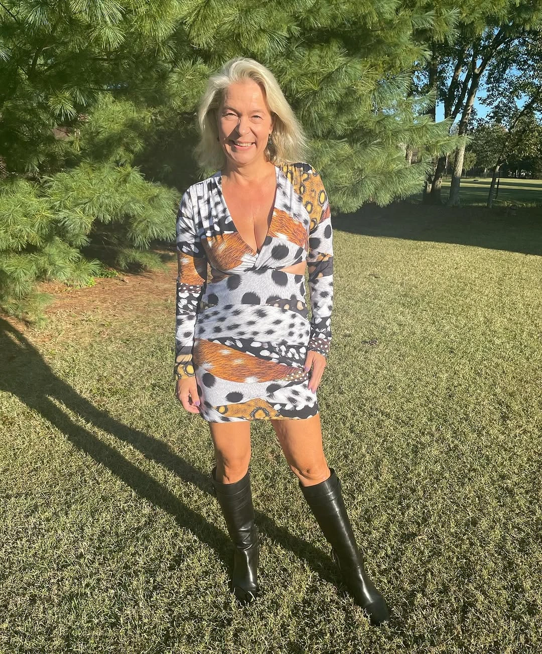 Black, white and orange patterned dress with black knee-high boots