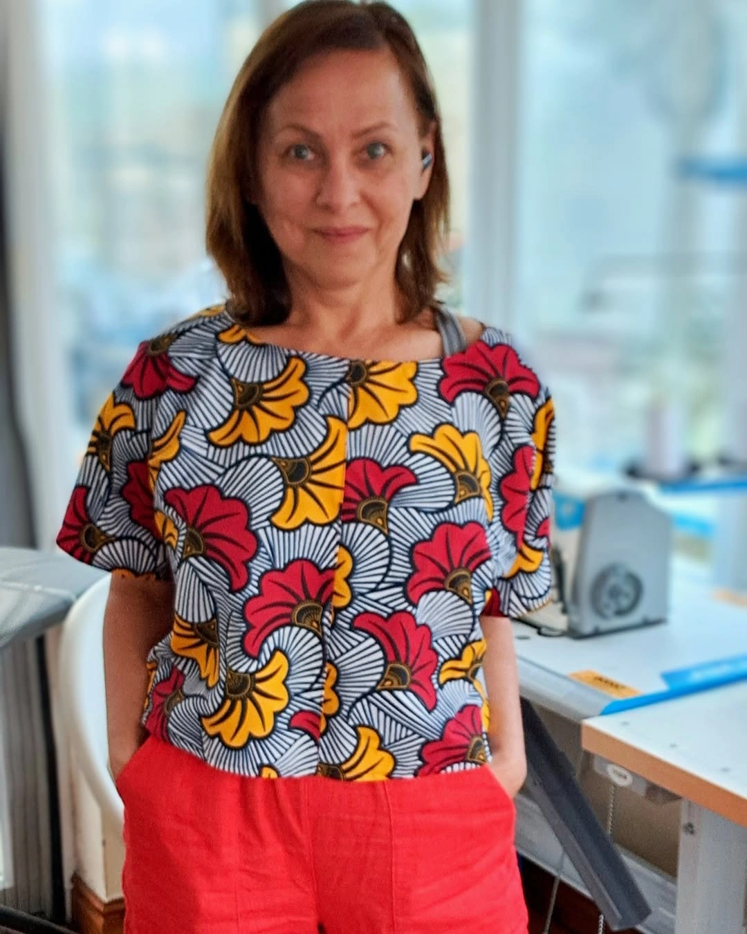 Graphic floral short-sleeve top with red-orange trousers
