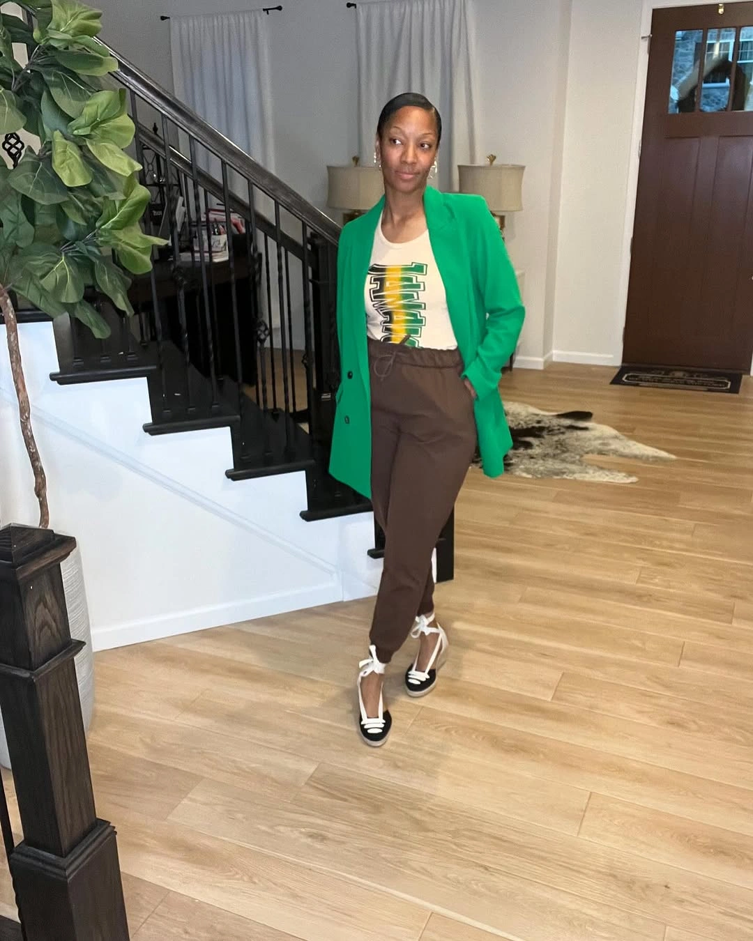 Green blazer, graphic white T-shirt, brown trousers and lace-up shoes