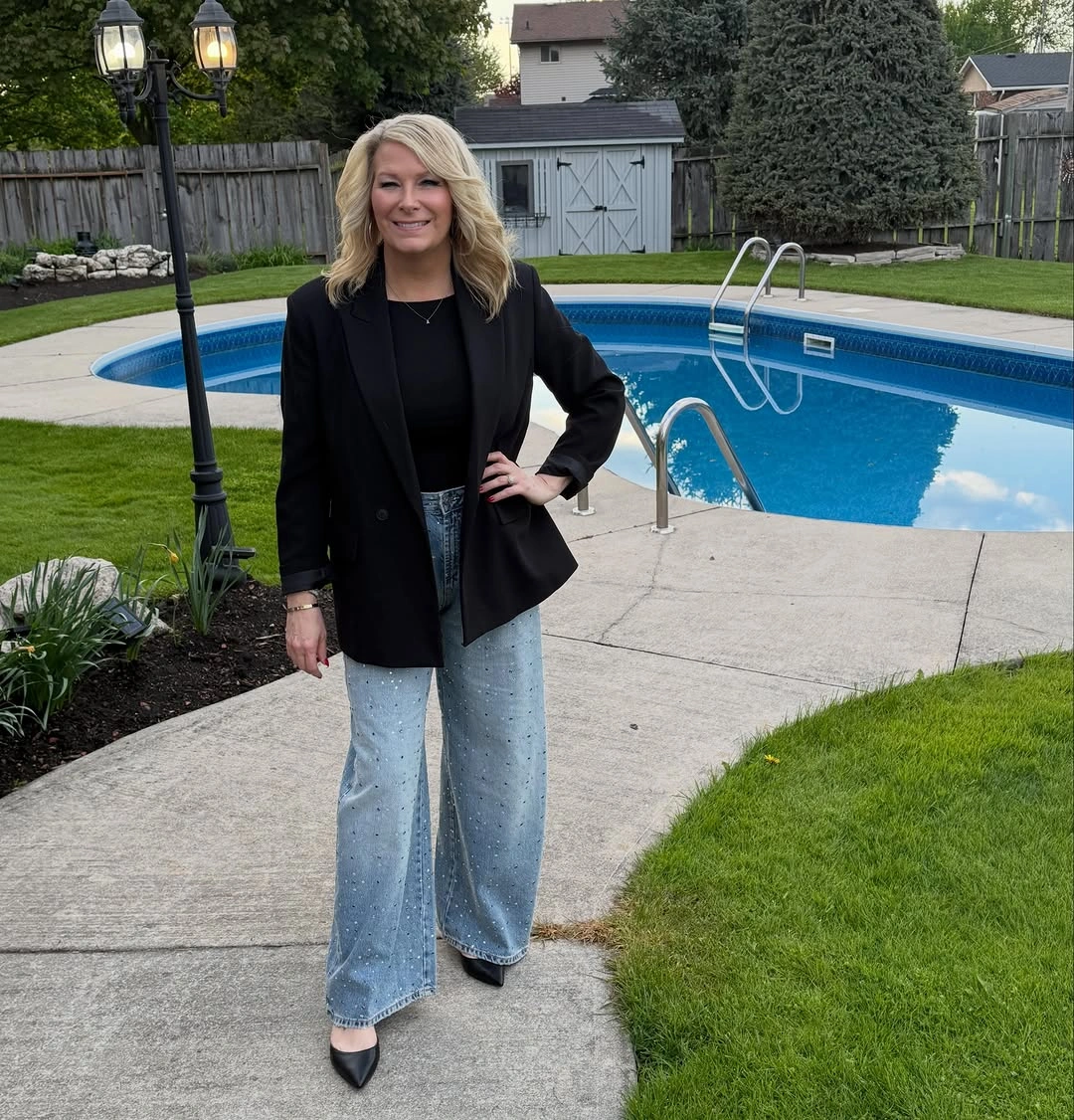Woman in black blazer with pale wide-leg jeans