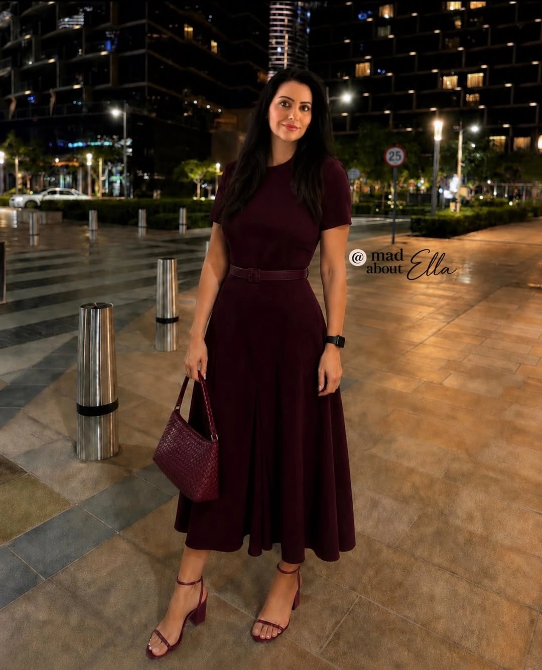 Woman in burgundy belted midi dress with matching accessories