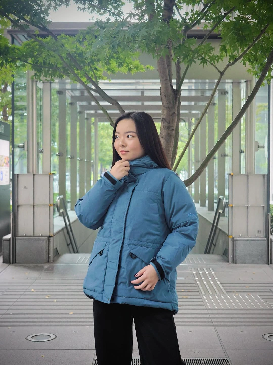 Mid blue puffer jacket with wide black pants
