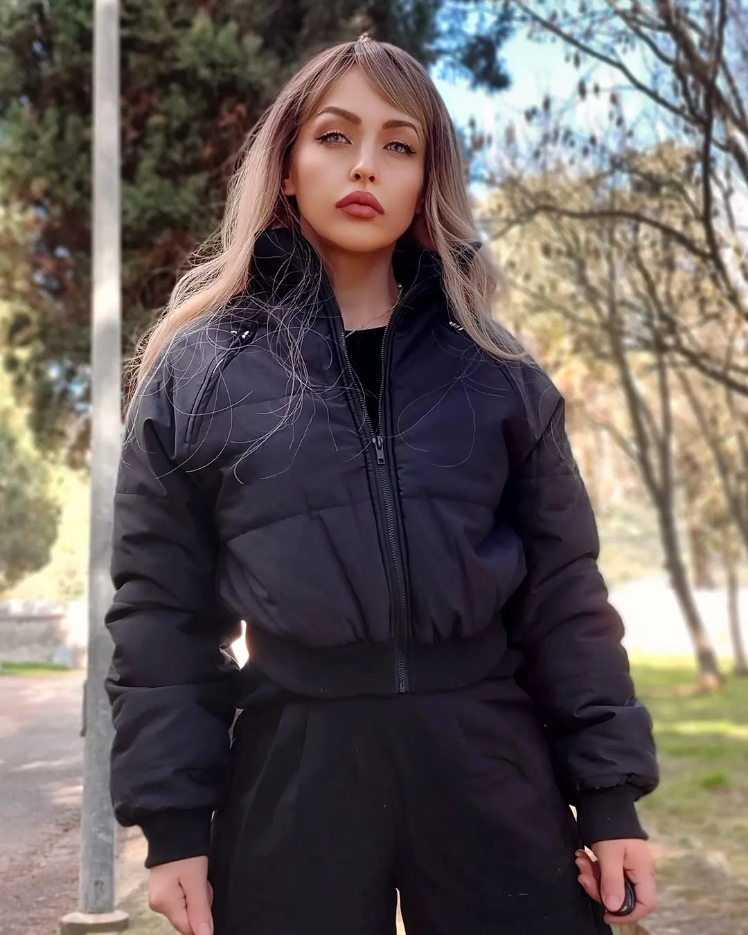 Black cropped puffer with high waist black trousers