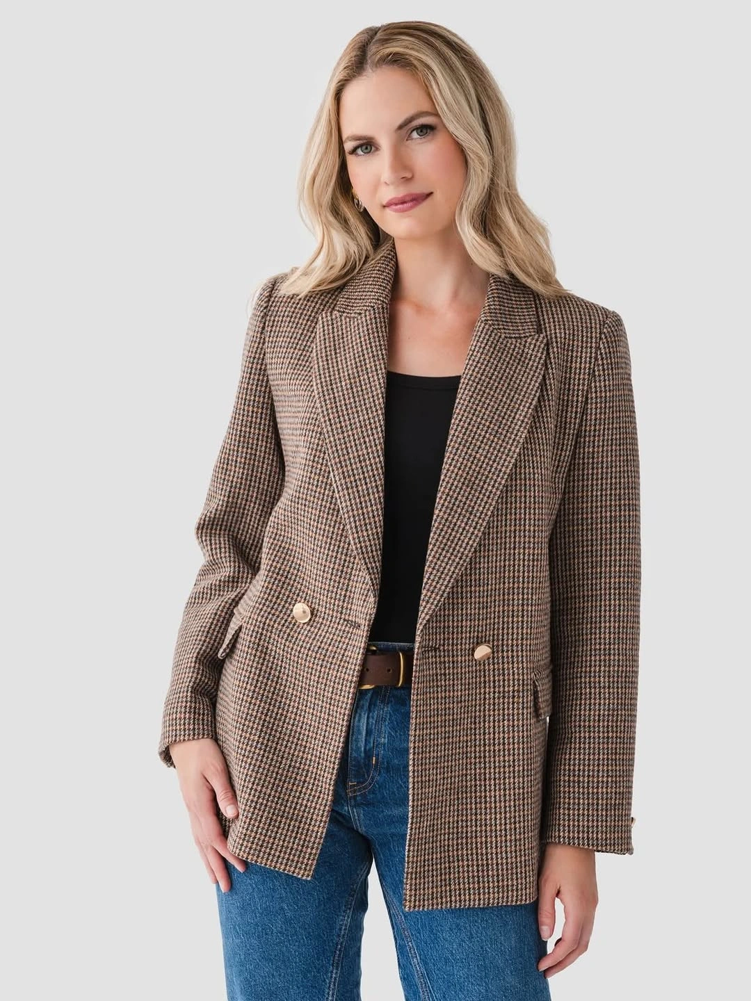 Brown checked blazer over black top and blue jeans