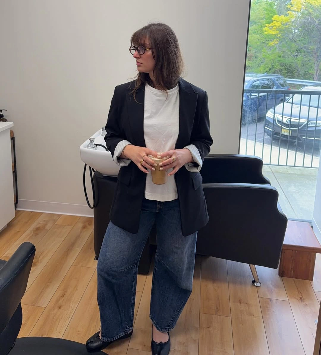 Black blazer with white T-shirt, loose jeans, and black flats