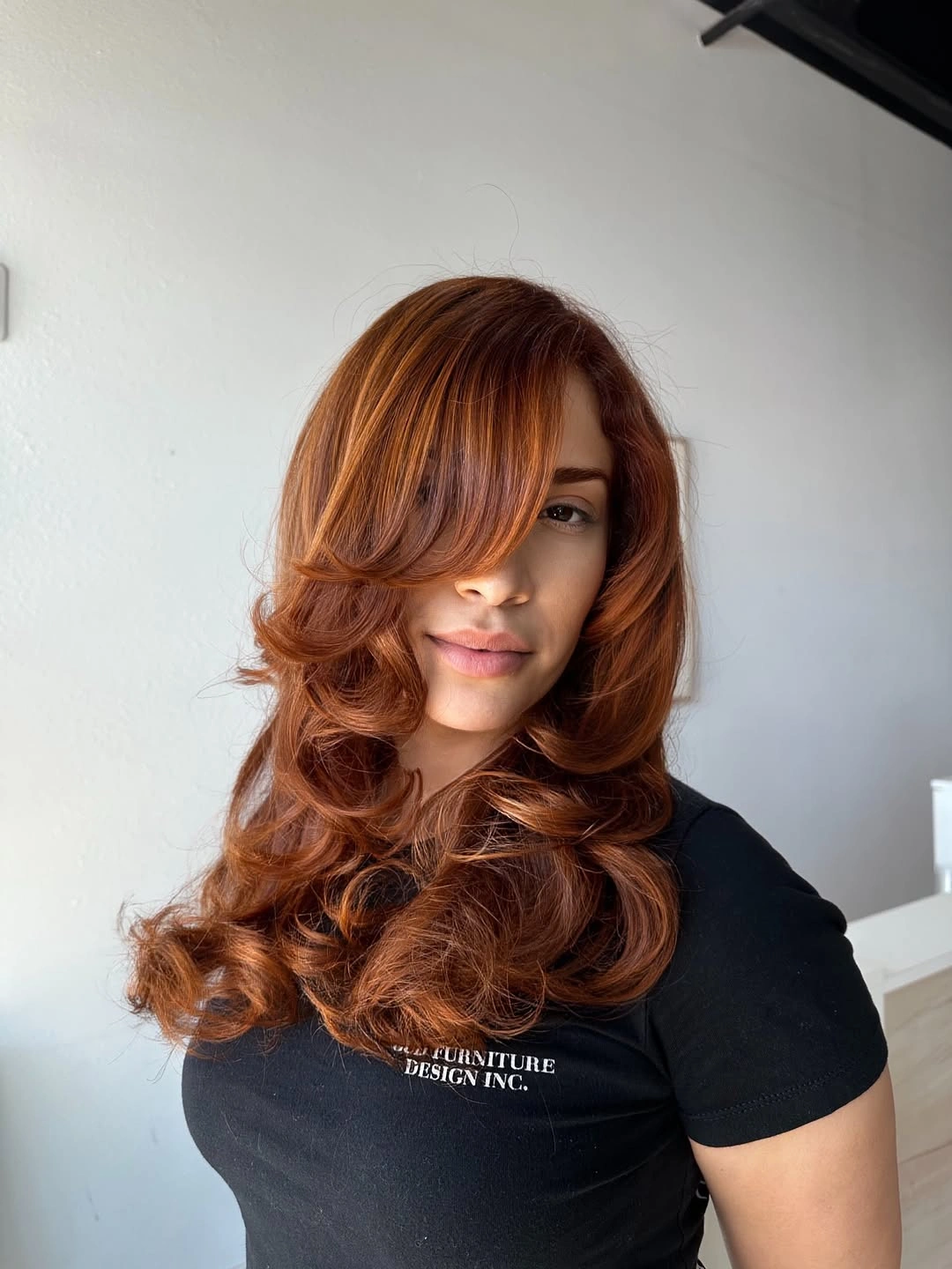warm auburn layered cut with side-swept fringe