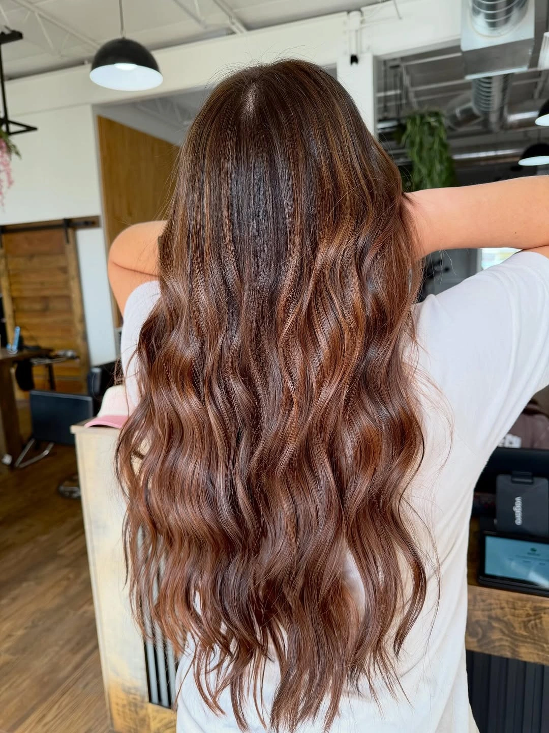 glossy chocolate-brown long waves with warm reflected sheen