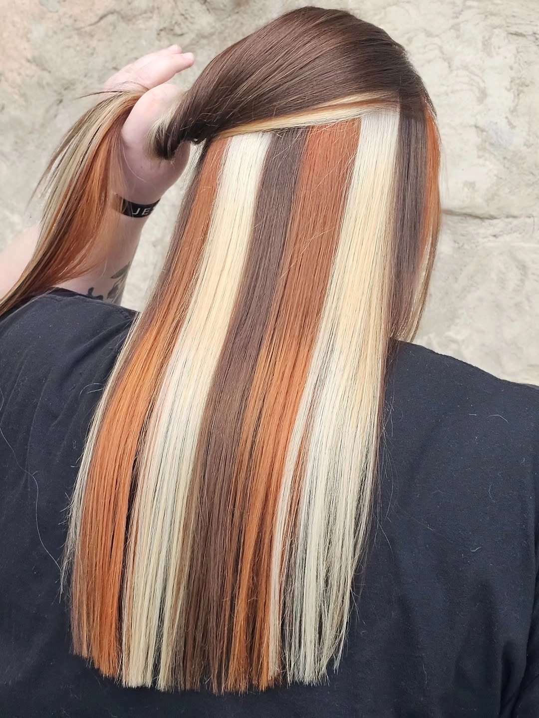 straight medium-brown hair with wide blonde and copper color panels