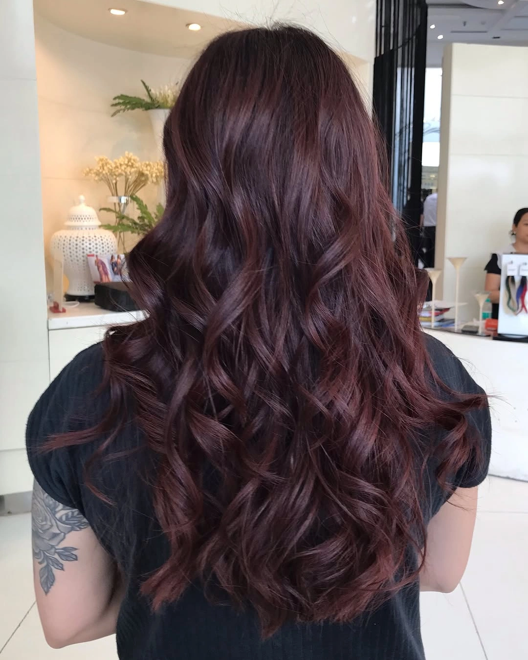 long chocolate waves with subdued plum-burgundy ribbons