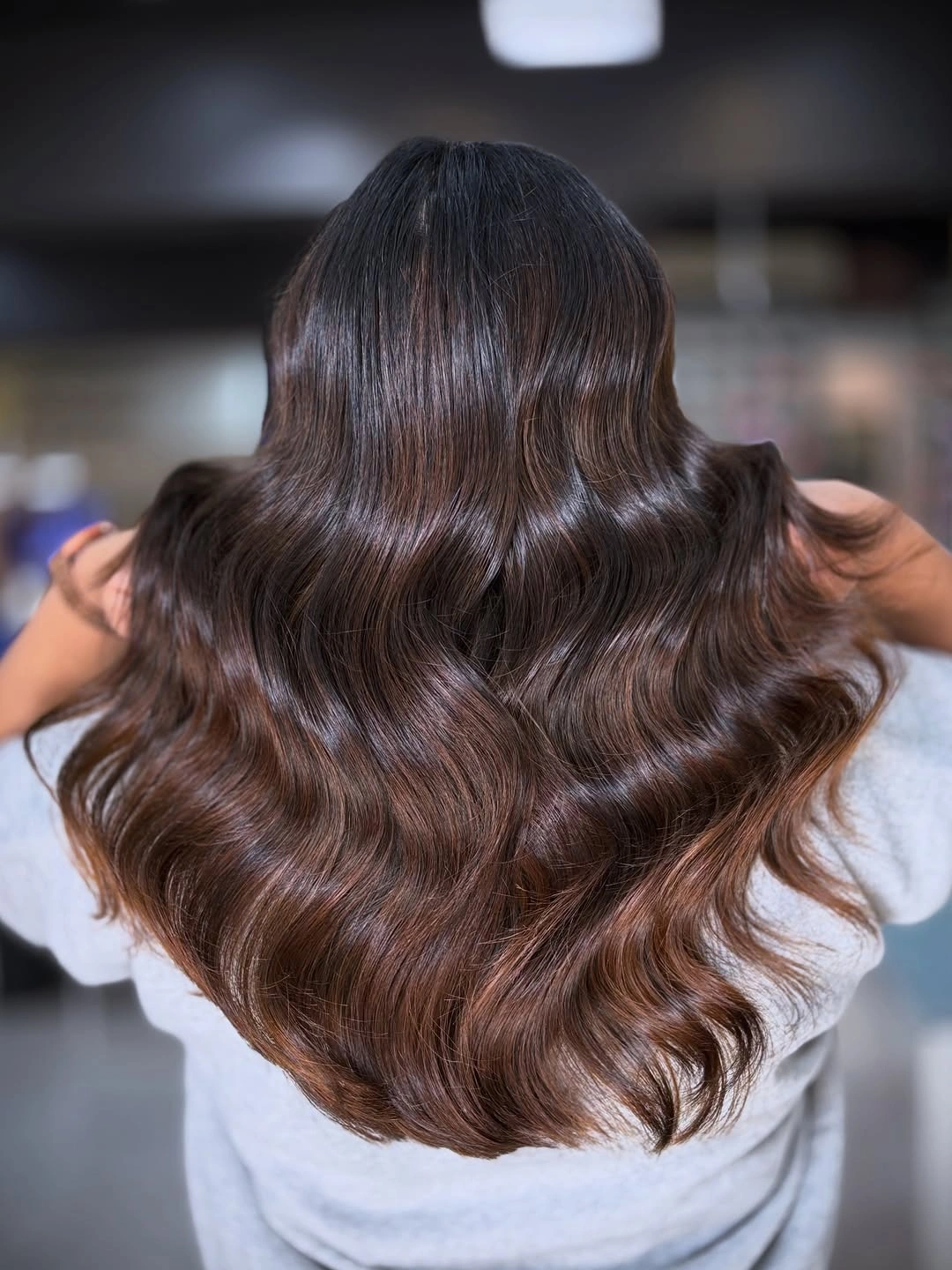 deep brunette long waves with a restrained warm sheen