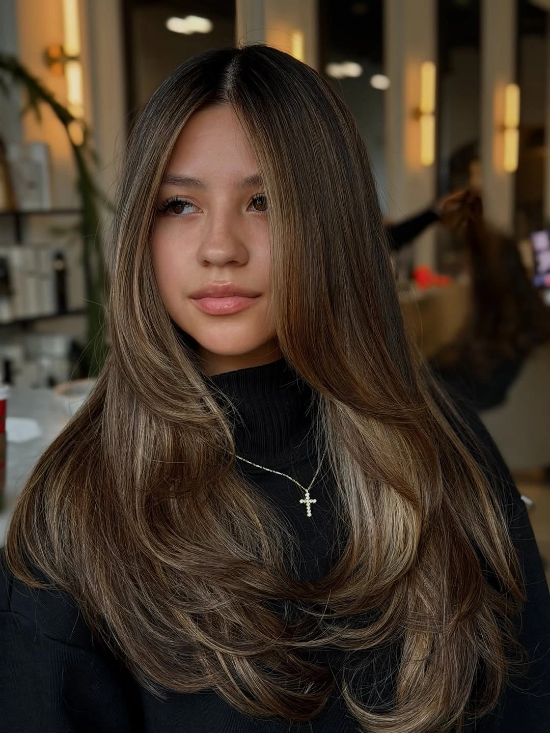 soft brown layered waves with a muted face-framing brightness