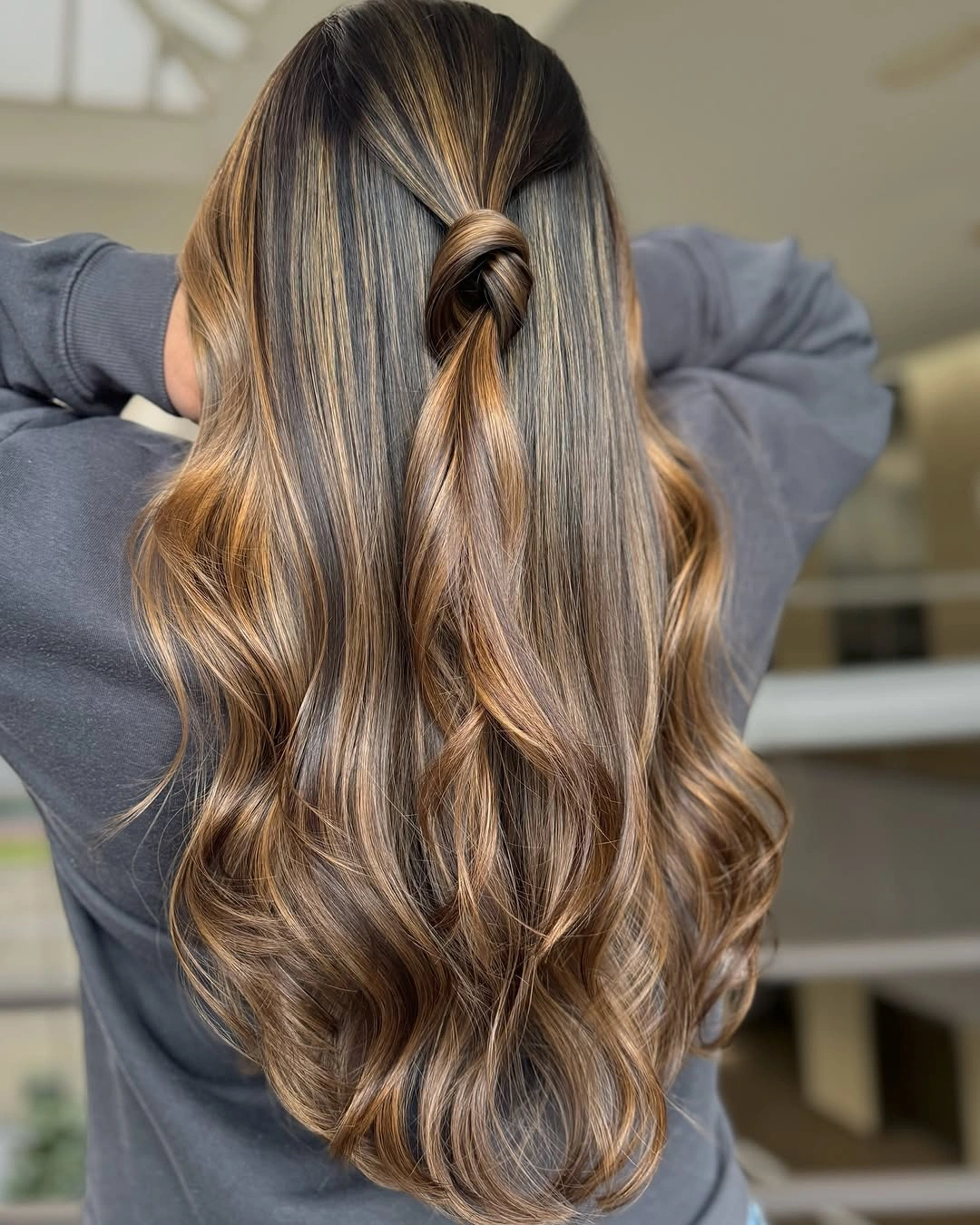 long bronde waves, half-up twist, and fine blonde dimension