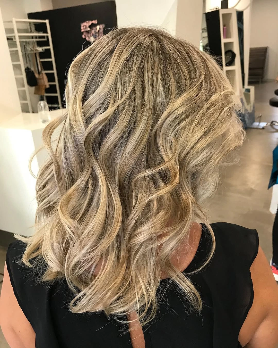 Short wavy blonde bob with dark lowlights and bright ribbons
