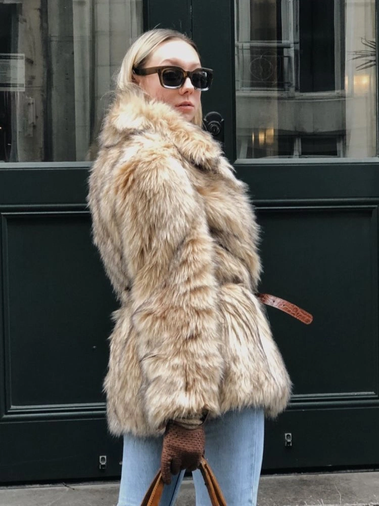 Pale patterned textured-looking coat with light jeans and brown accessories