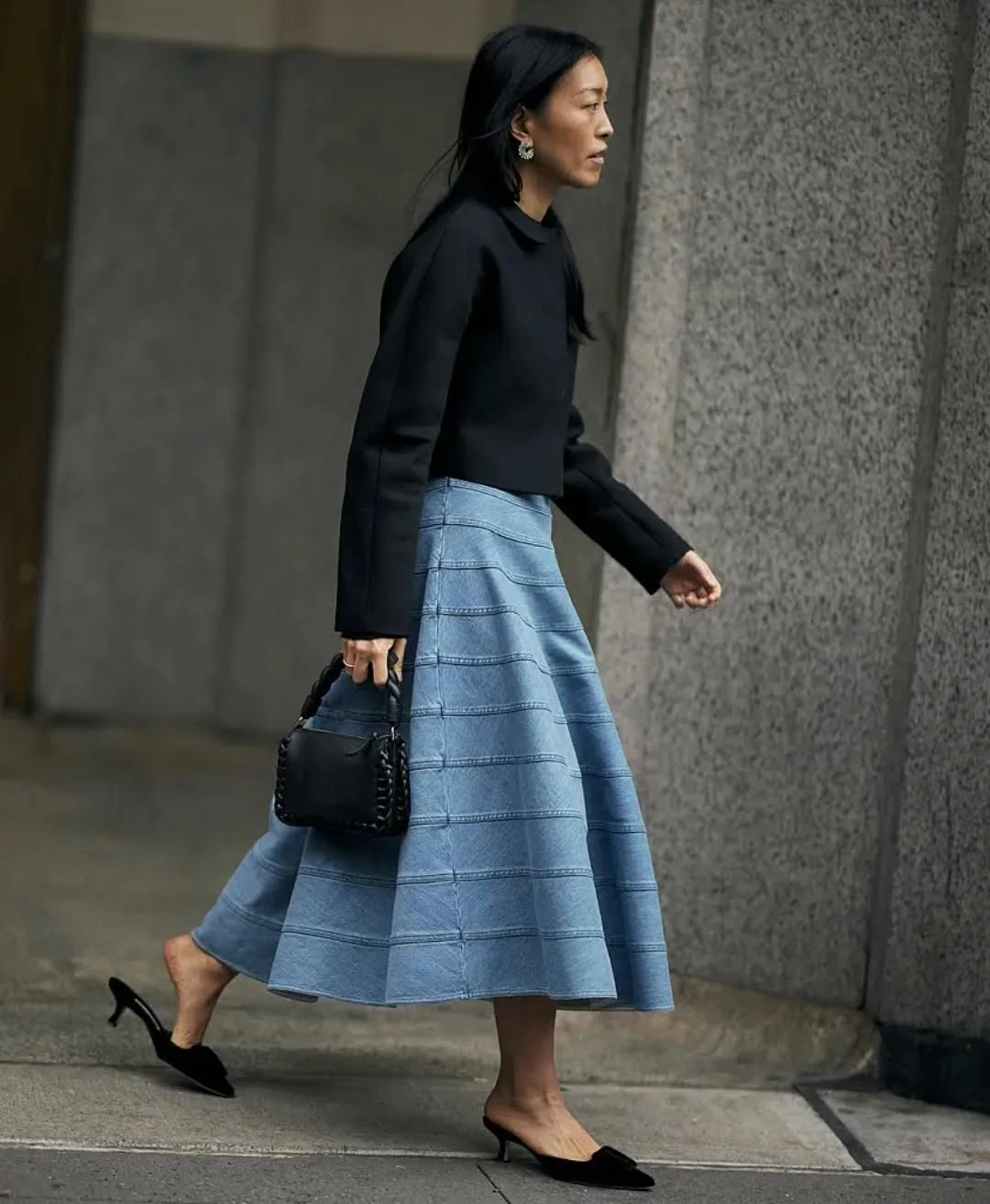 Black cropped top with pale blue full skirt and pointed heels