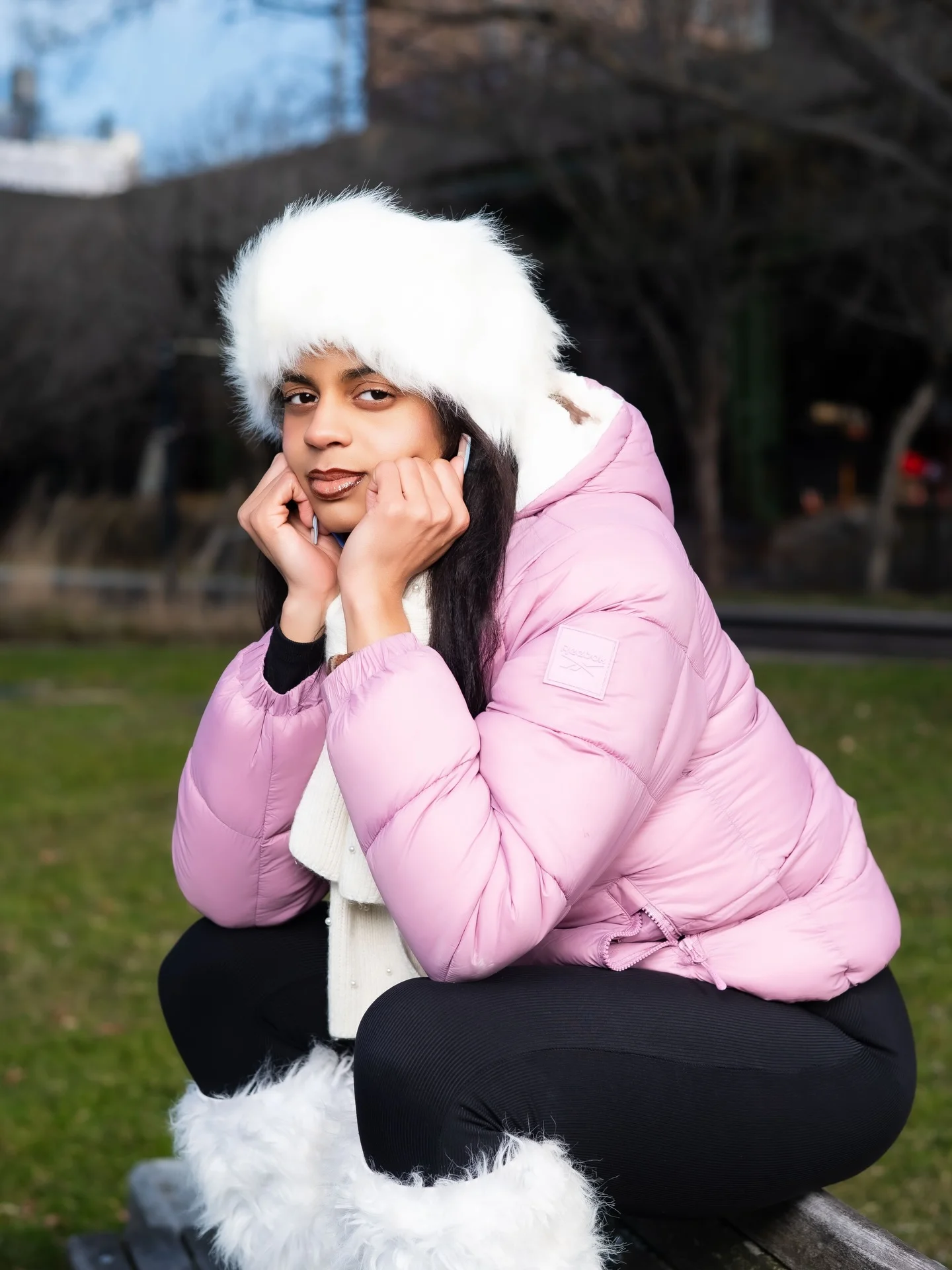 Pink quilted puffer with white hat, scarf, and fluffy-looking boots