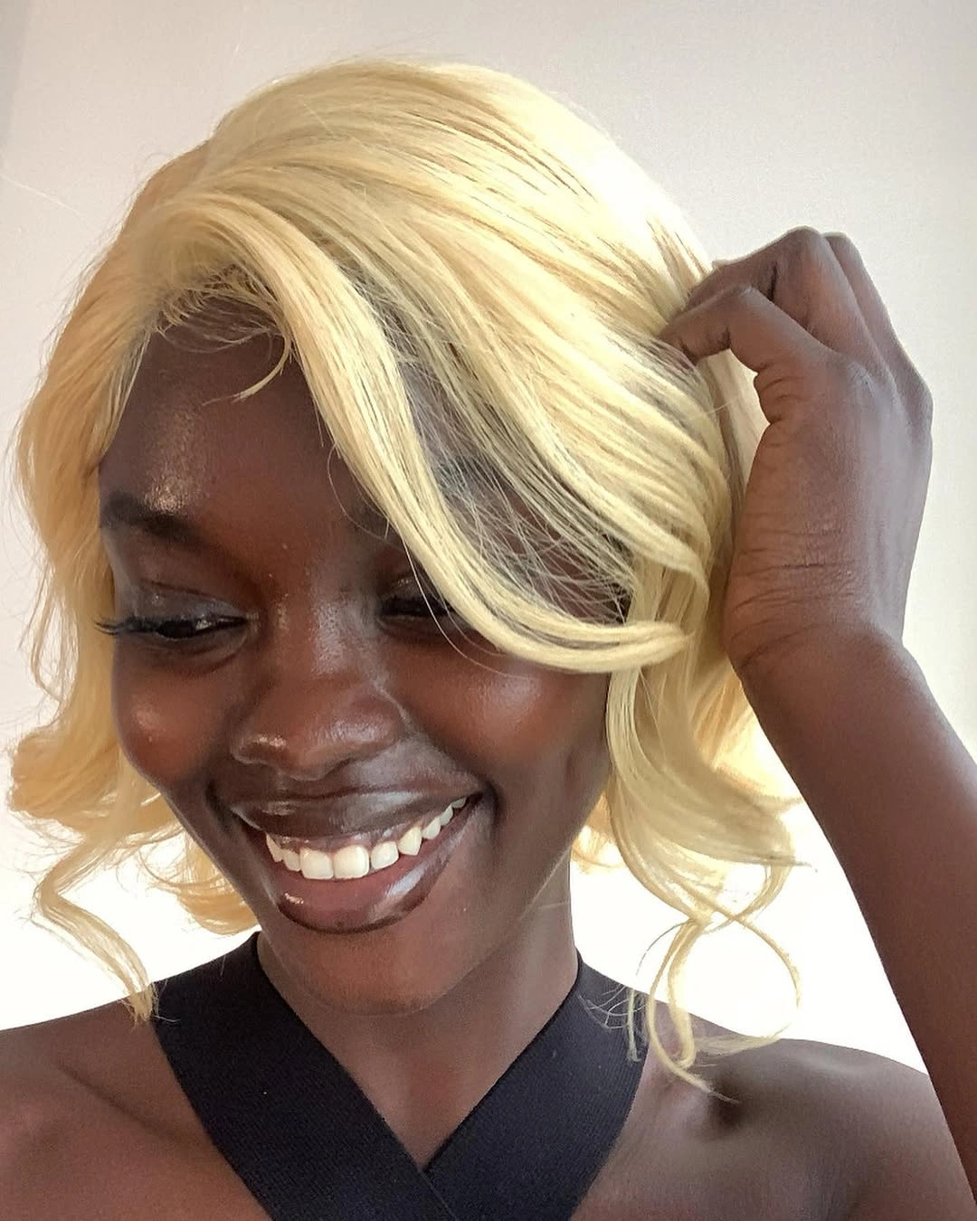 Short pale blonde bob with side swept curved ends
