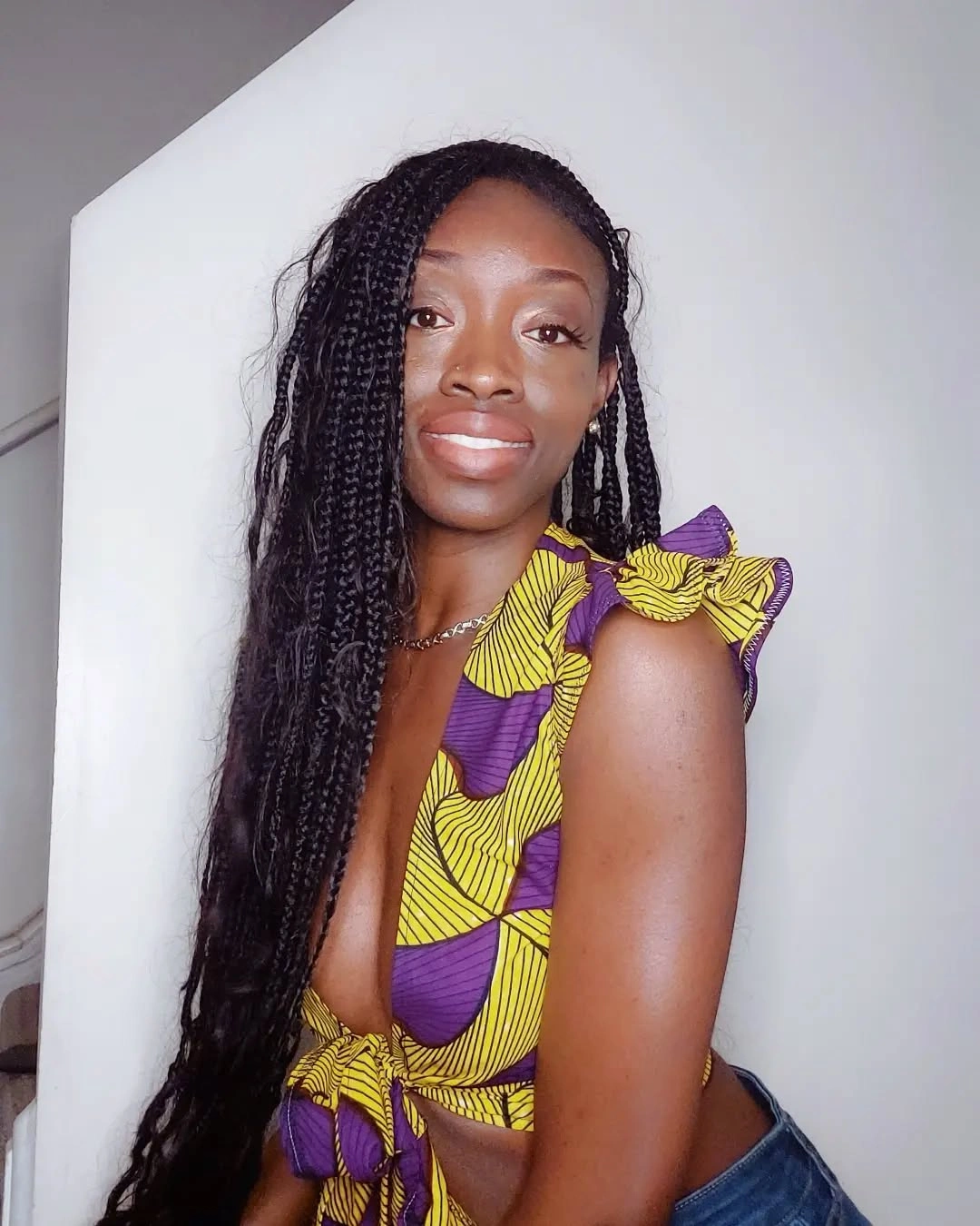 Long black small braids falling over one shoulder