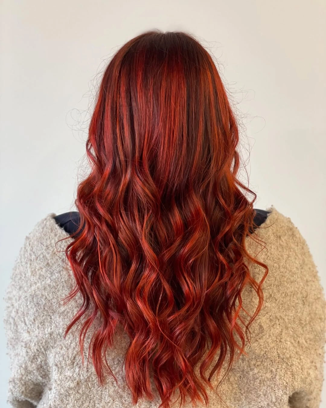 Long wavy deep red copper hair with darker roots