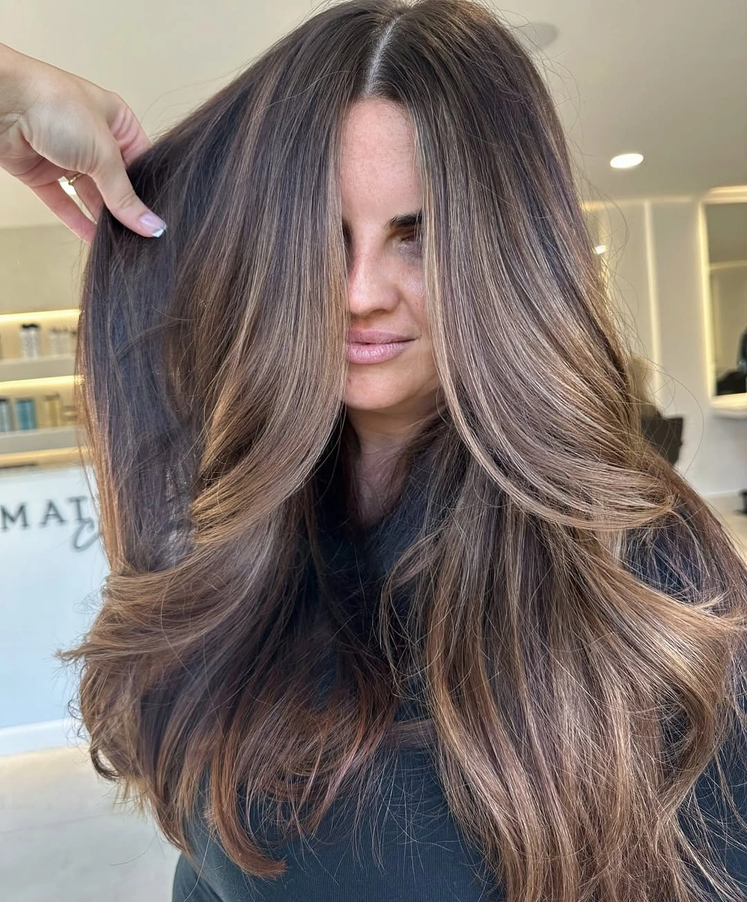 Long dark brown hair with warm beige face-framing highlights