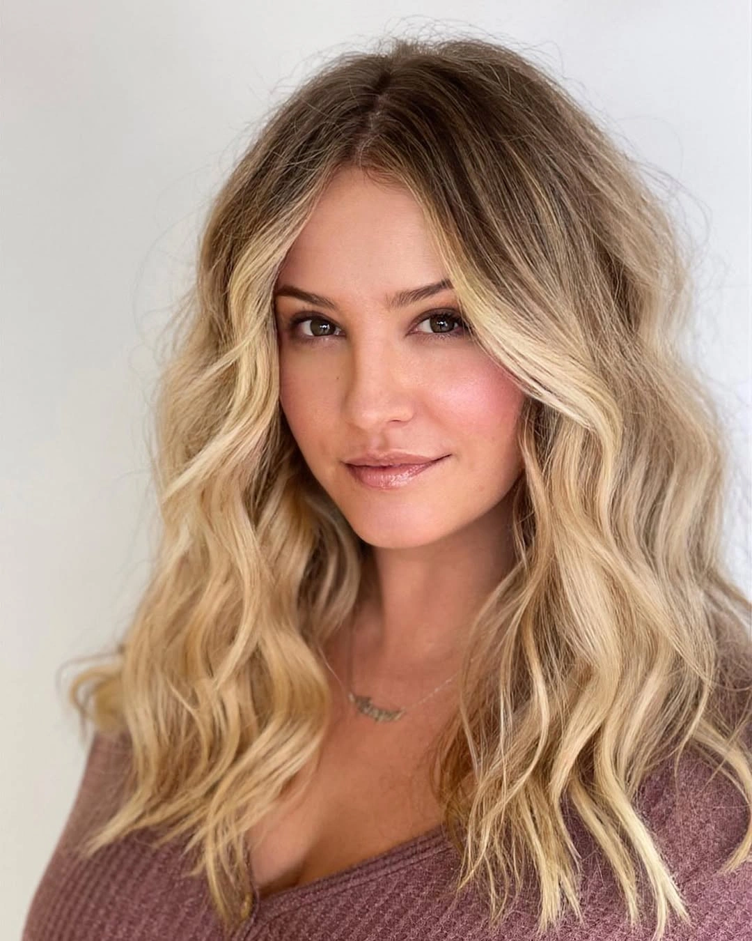 Medium-to-long bright blonde wavy hair from the front