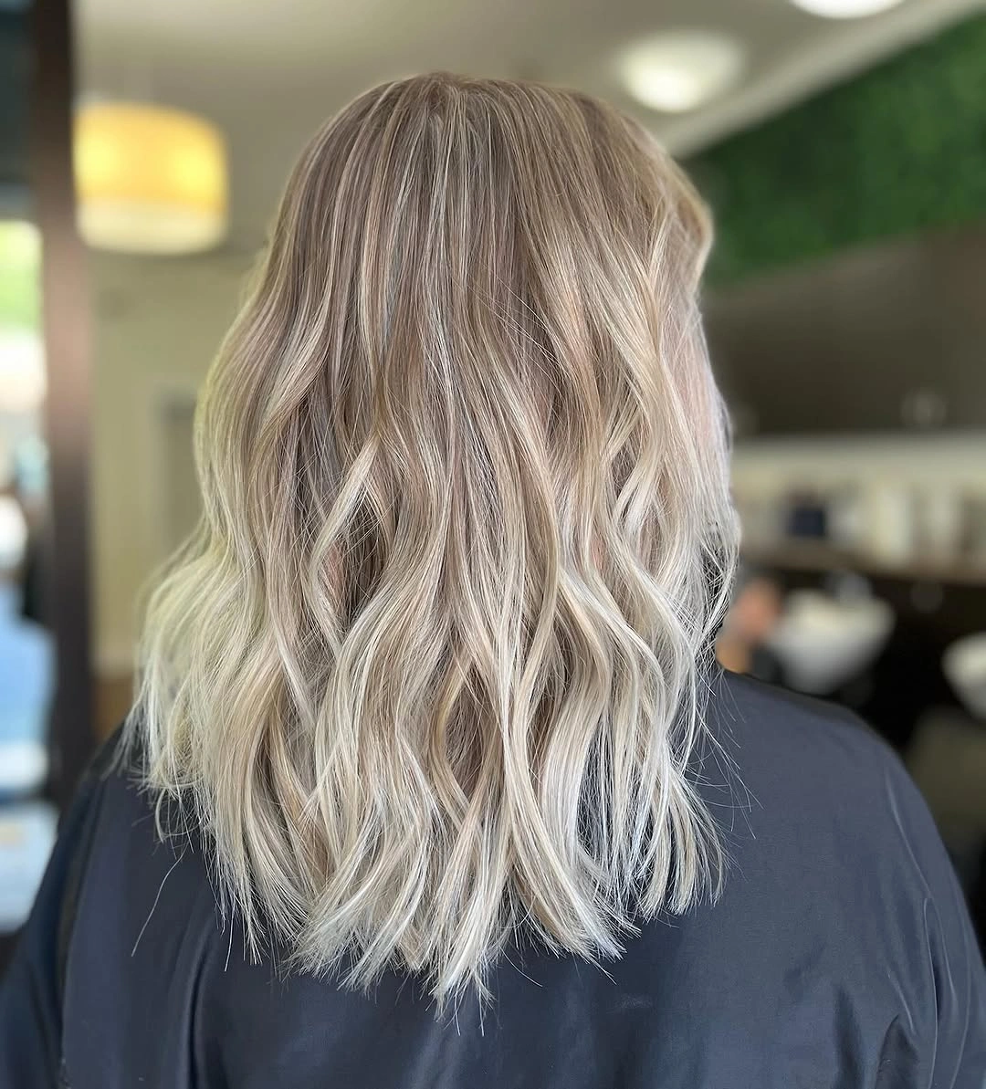 Shoulder-length wavy icy cream blonde hair from the back