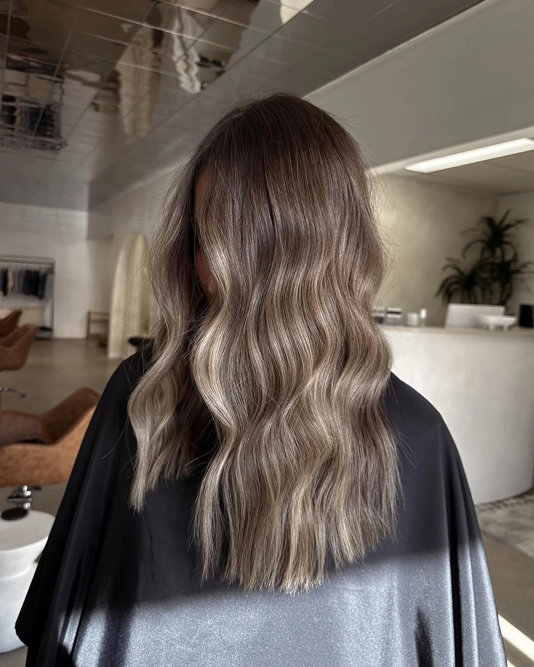 Long wavy gray taupe ash blonde hair from the back