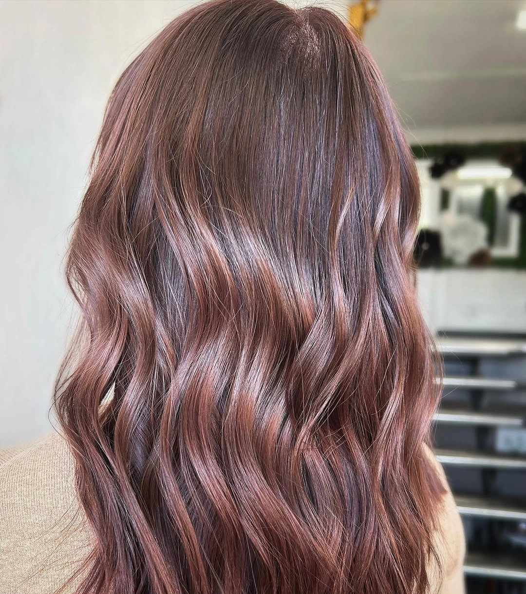 Long wavy hair in muted mauve lilac-brown color