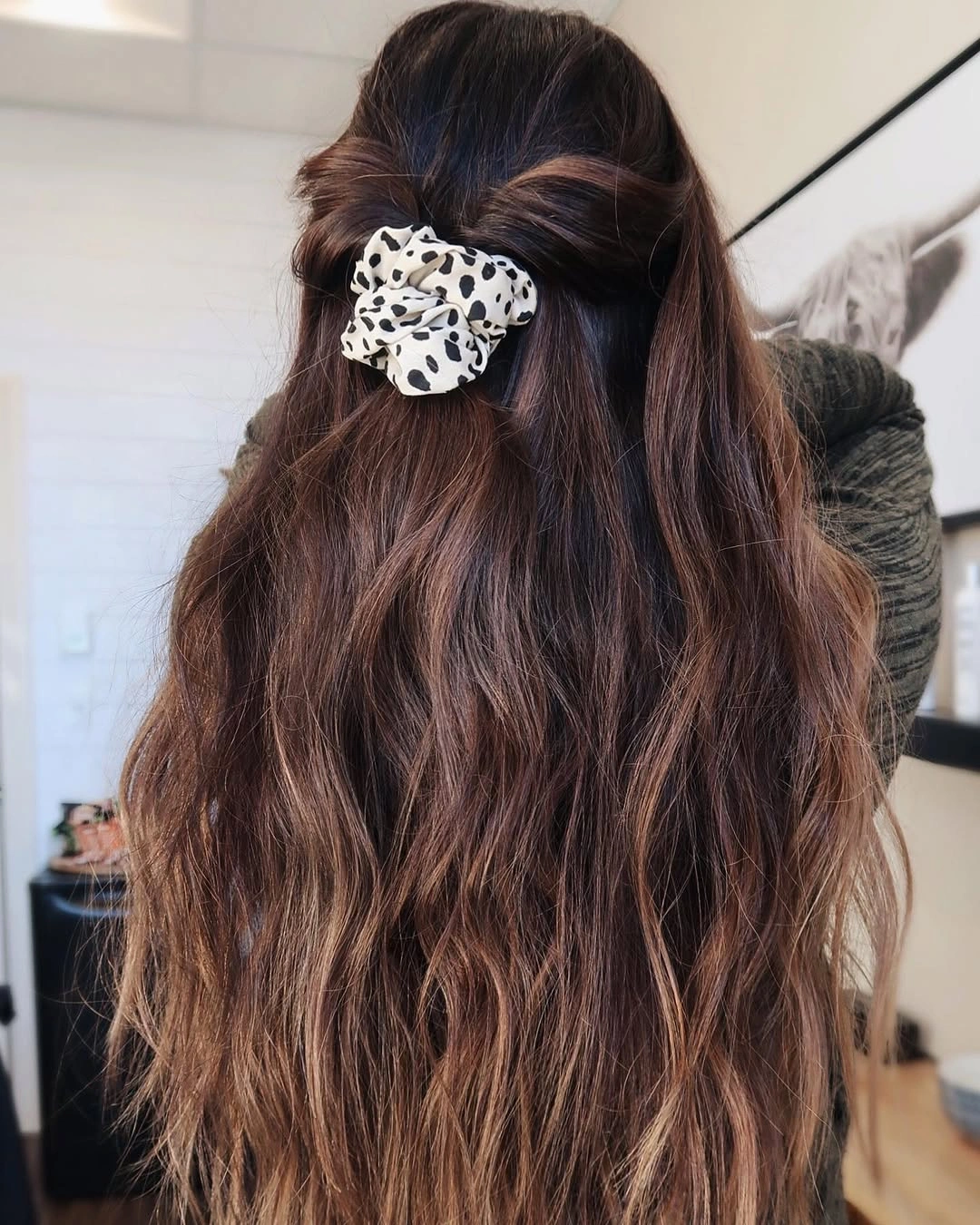 Long wavy brown hair half-up with leopard-print scrunchie