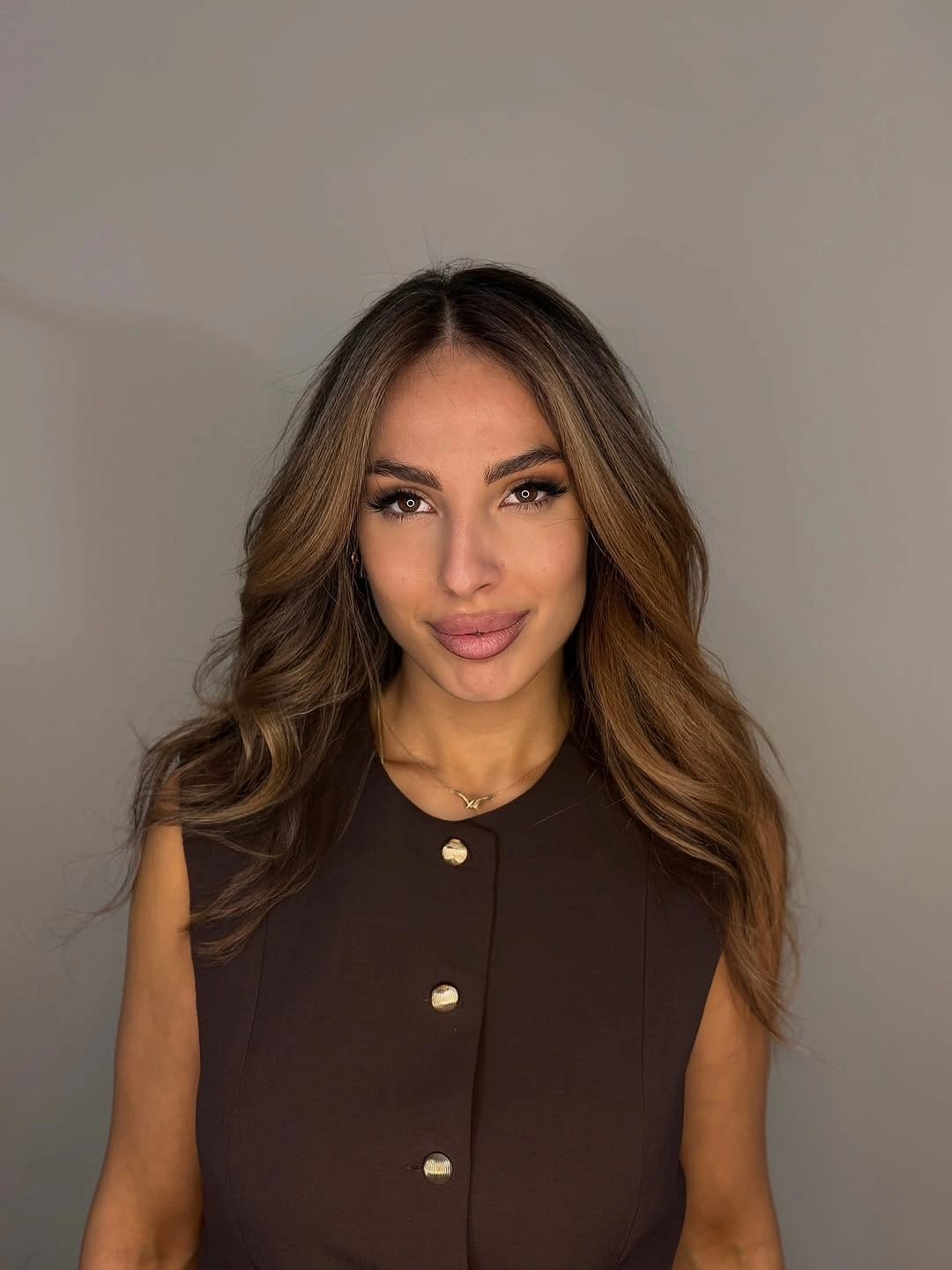 Long dark brown wavy hair with face-framing pieces