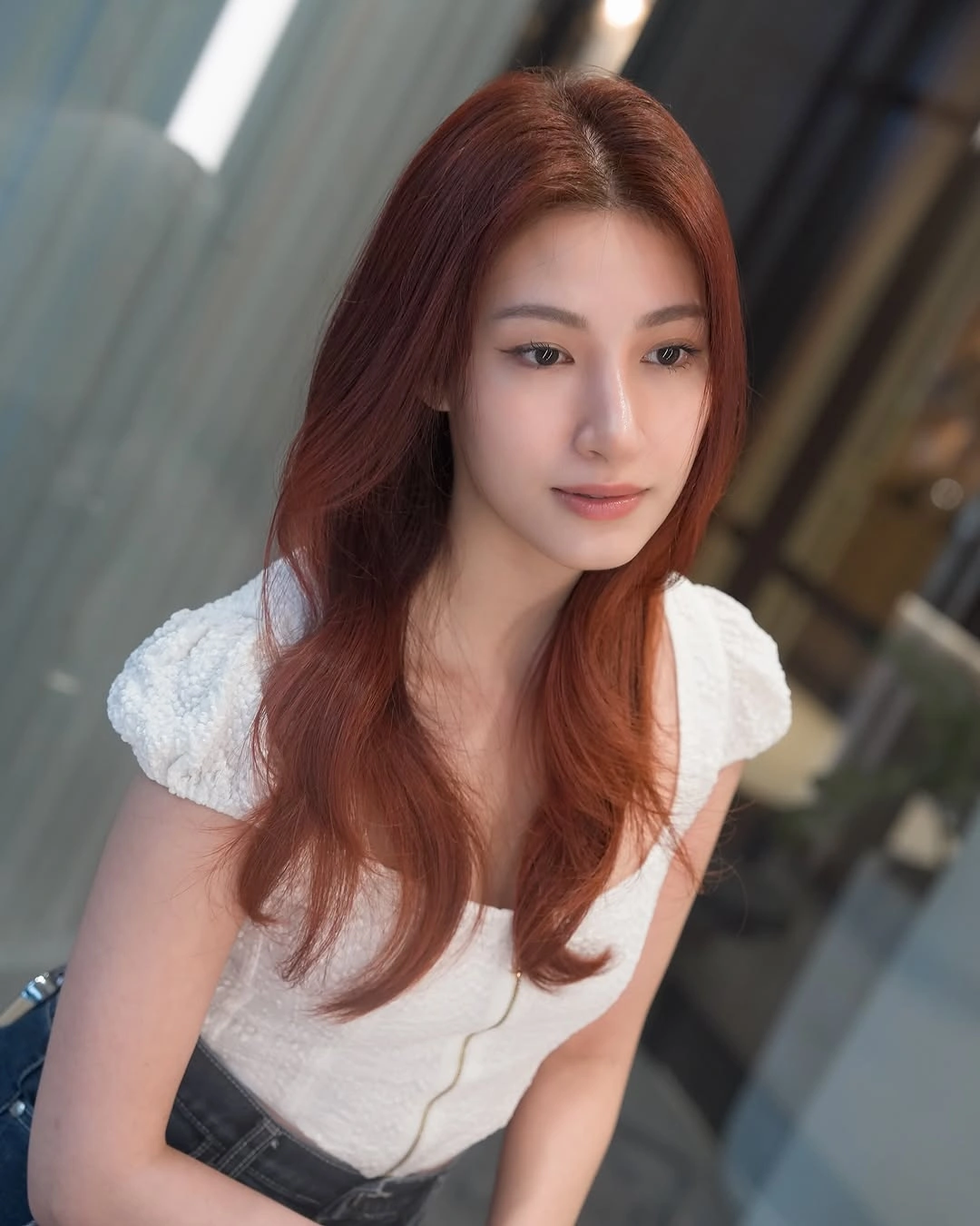 Long wavy copper-red hair with face-framing pieces