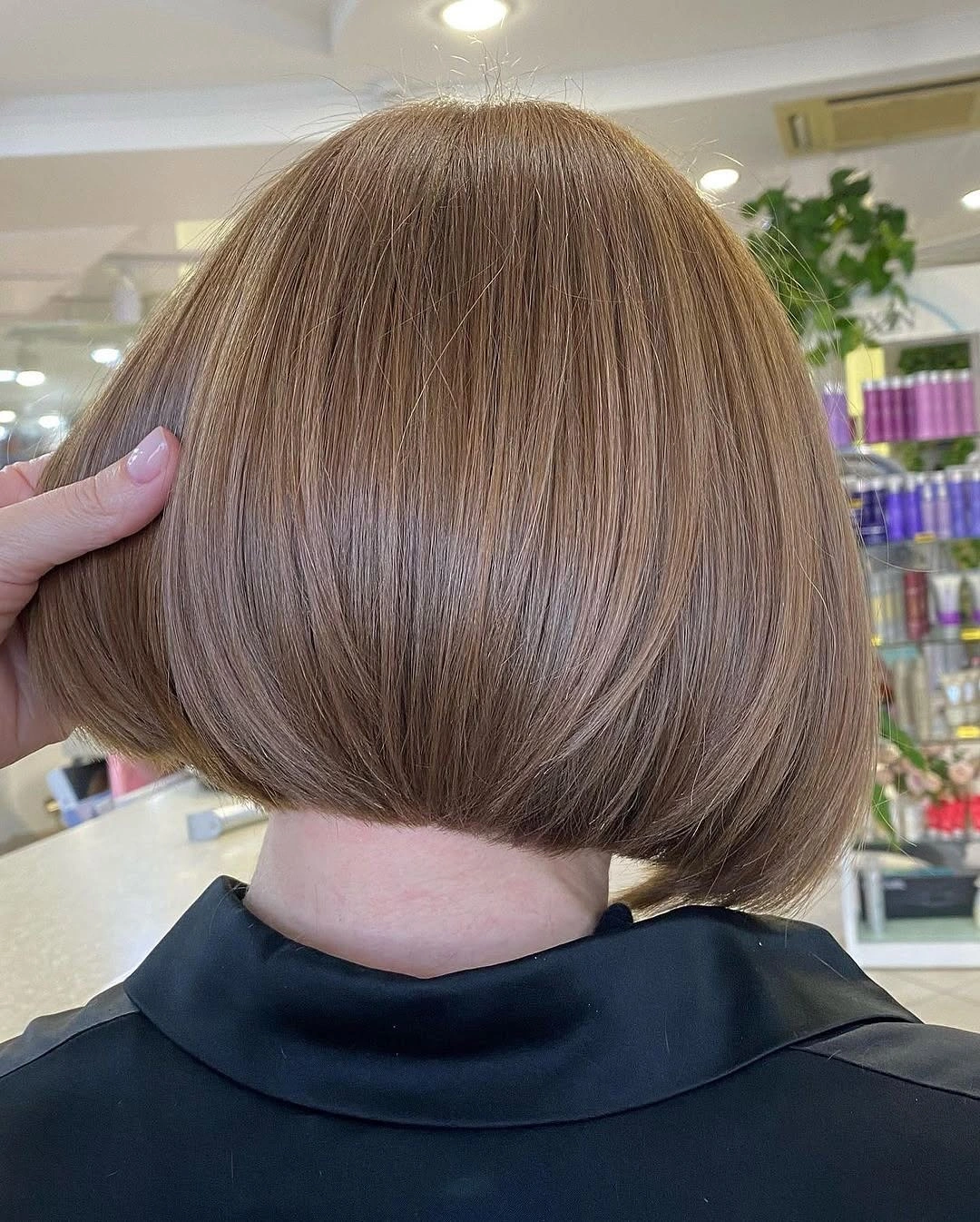 Short rounded brown bob ending around the jawline seen from the back