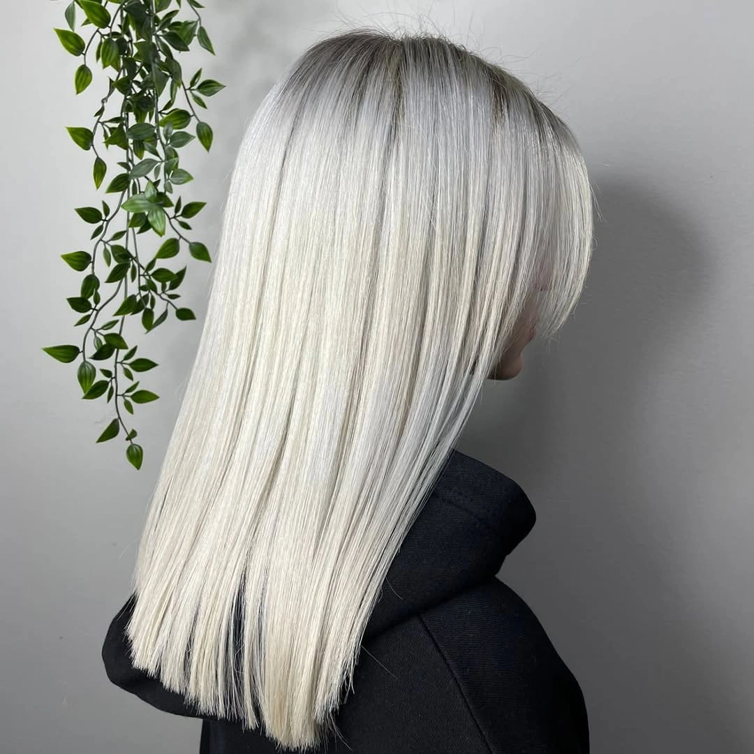 Long straight platinum-white hair with an even blunt-looking edge
