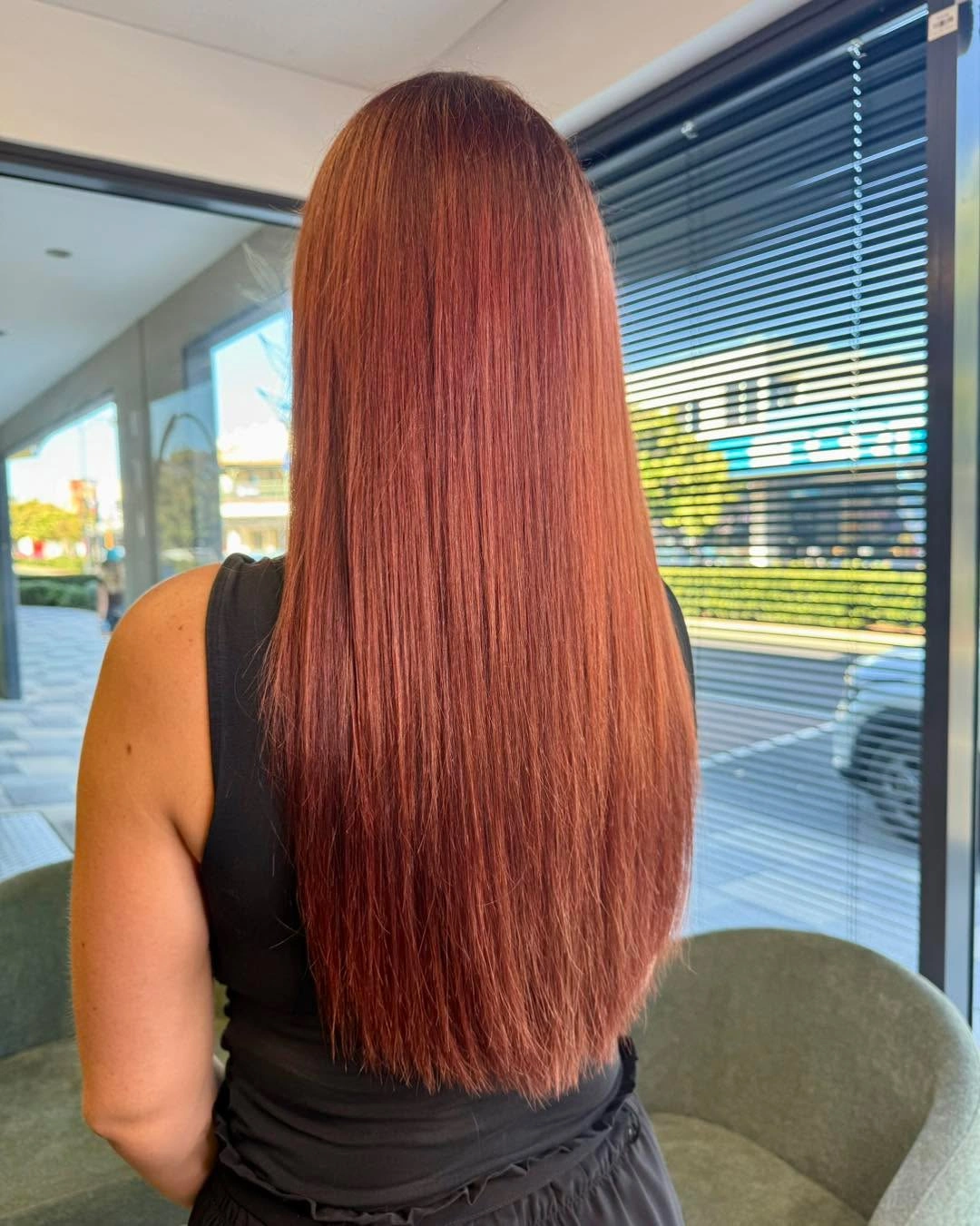 Very long straight copper-red hair with an even blunt-looking edge