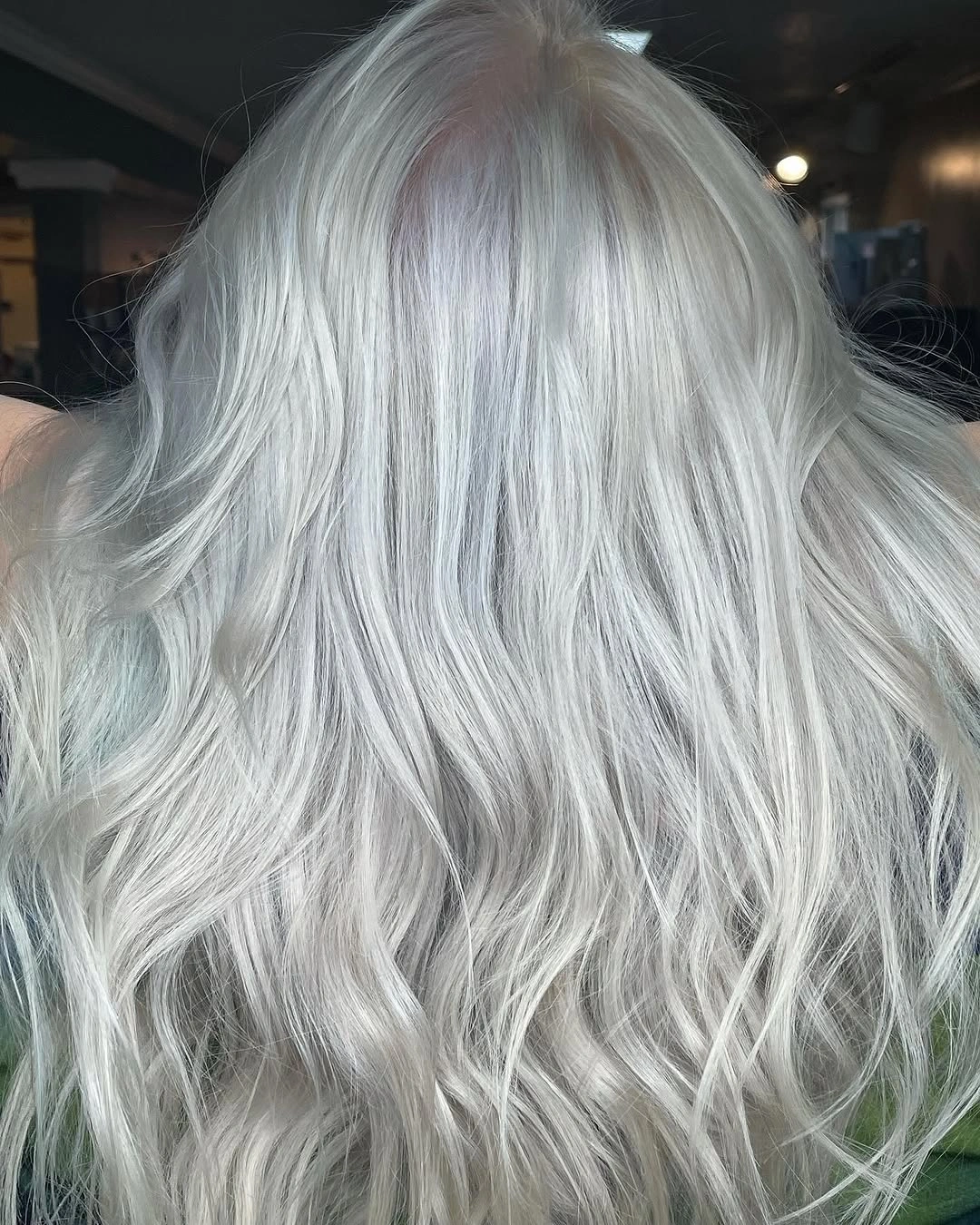 Long icy silver wavy hair shown from the back