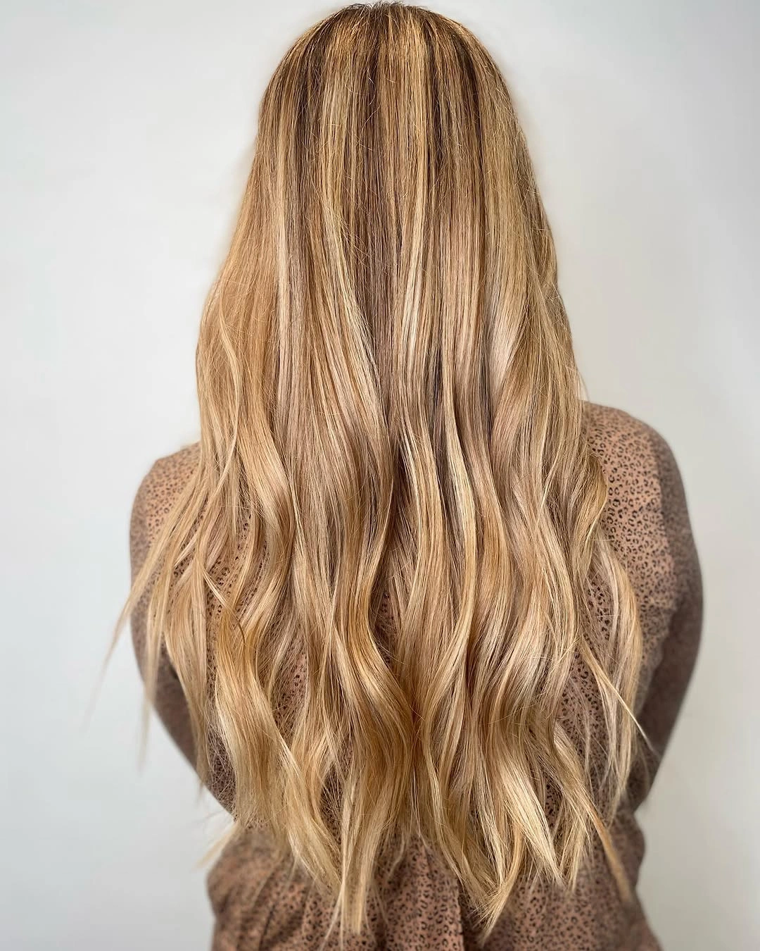 Long wavy caramel-light hair with loose layers