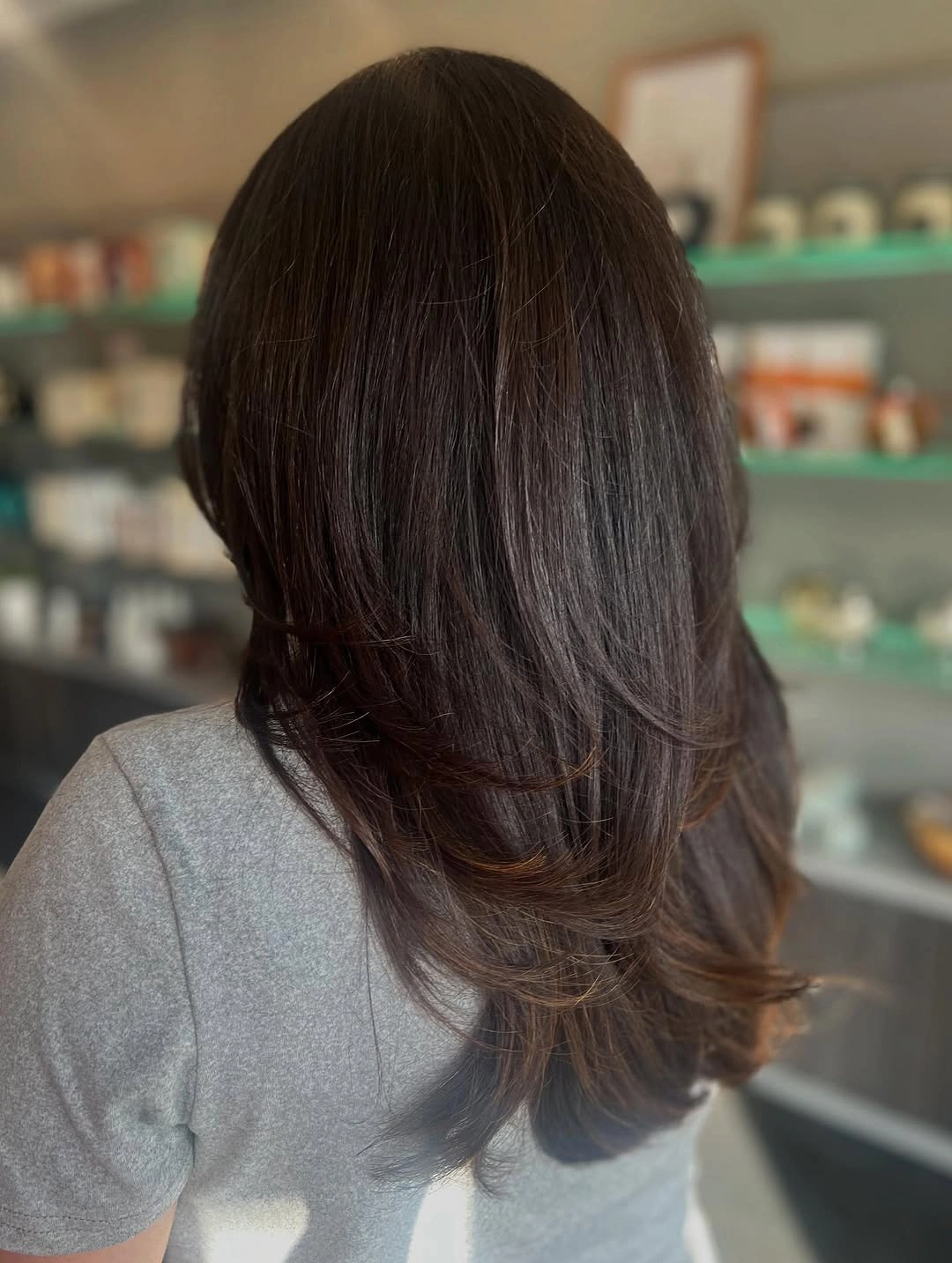 Dark long layered hair with soft curved lower ends