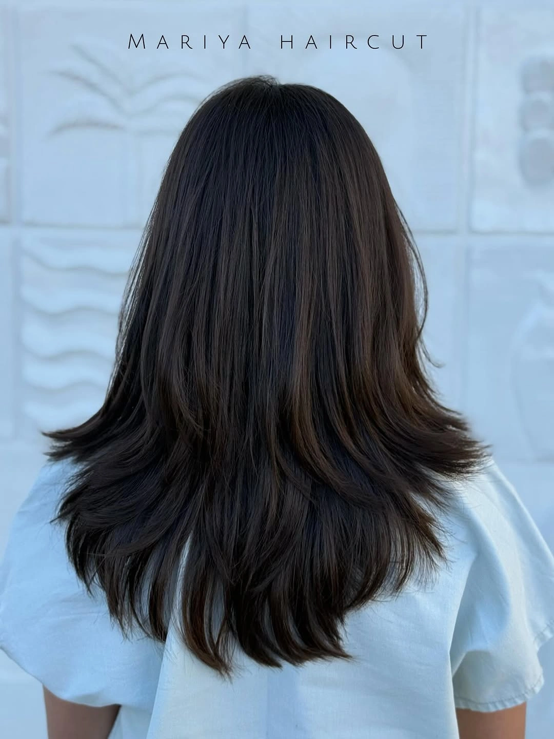 Long dark layered hair with flipped-out ends