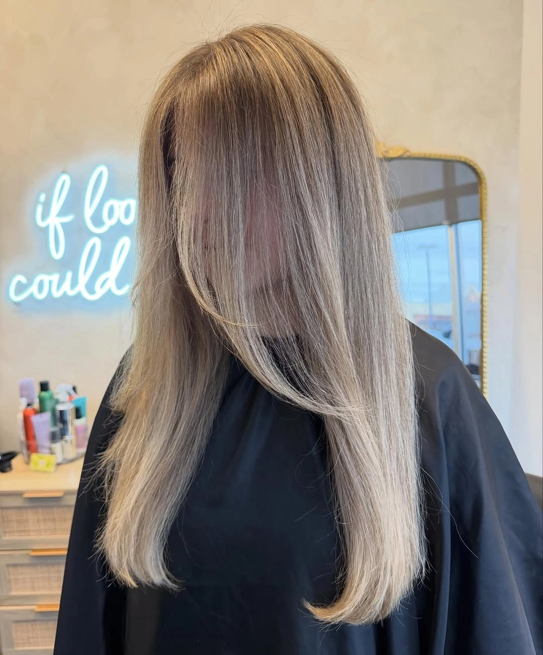 Long pale blonde hair with darker crown and layers