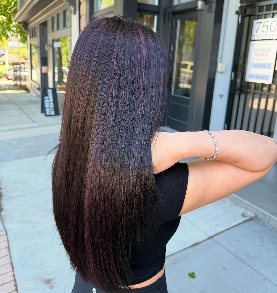 Very long straight dark hair with red-toned strands