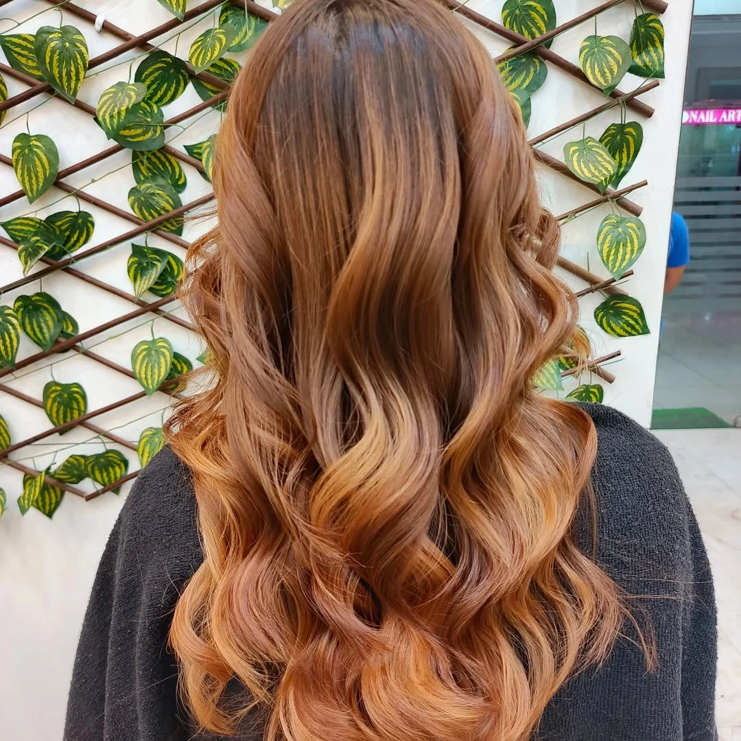 Long copper hair with honey-toned waves from behind