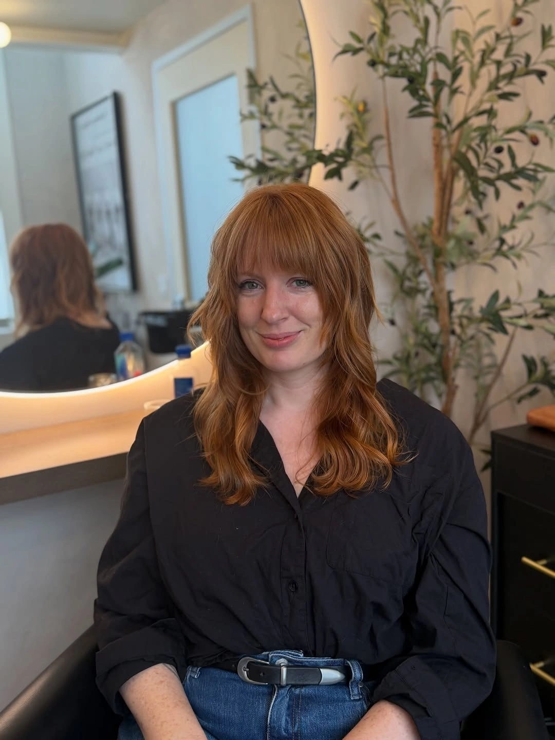 Long copper hair with full bangs and loose waves