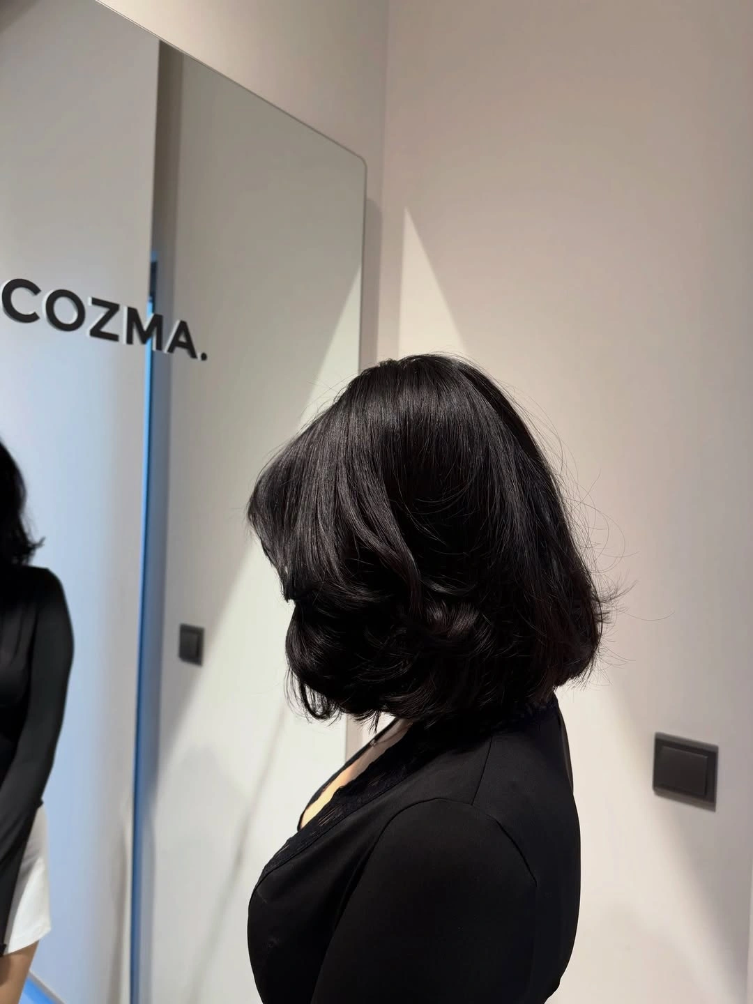 Black shoulder-length bob with rounded body and curled ends