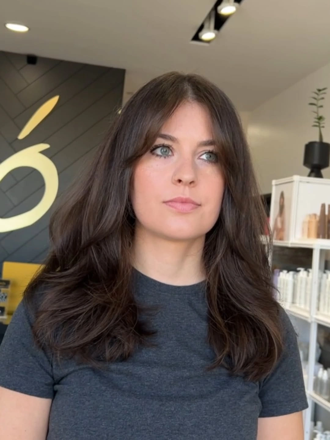 Dark medium-length layers with center part and bent ends
